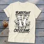 Cream t-shirt with black text and graphic of bare feet in water.