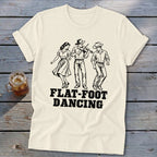 Cream t-shirt with black line art of three dancers and "FLAT-FOOT DANCING" text.