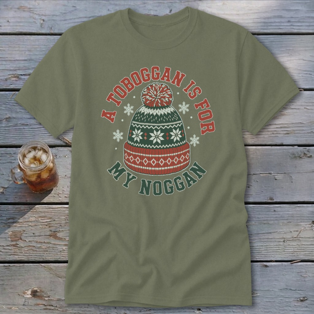 An olive green t-shirt featuring a graphic of a winter hat with text reading A toboggan is for my noggan.