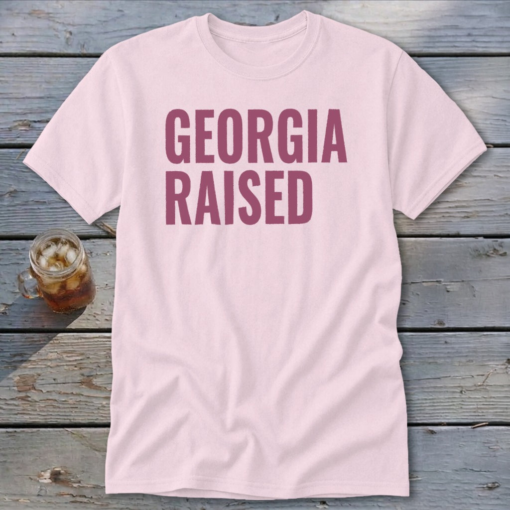 Pink t-shirt with "GEORGIA RAISED" in dark pink lettering.