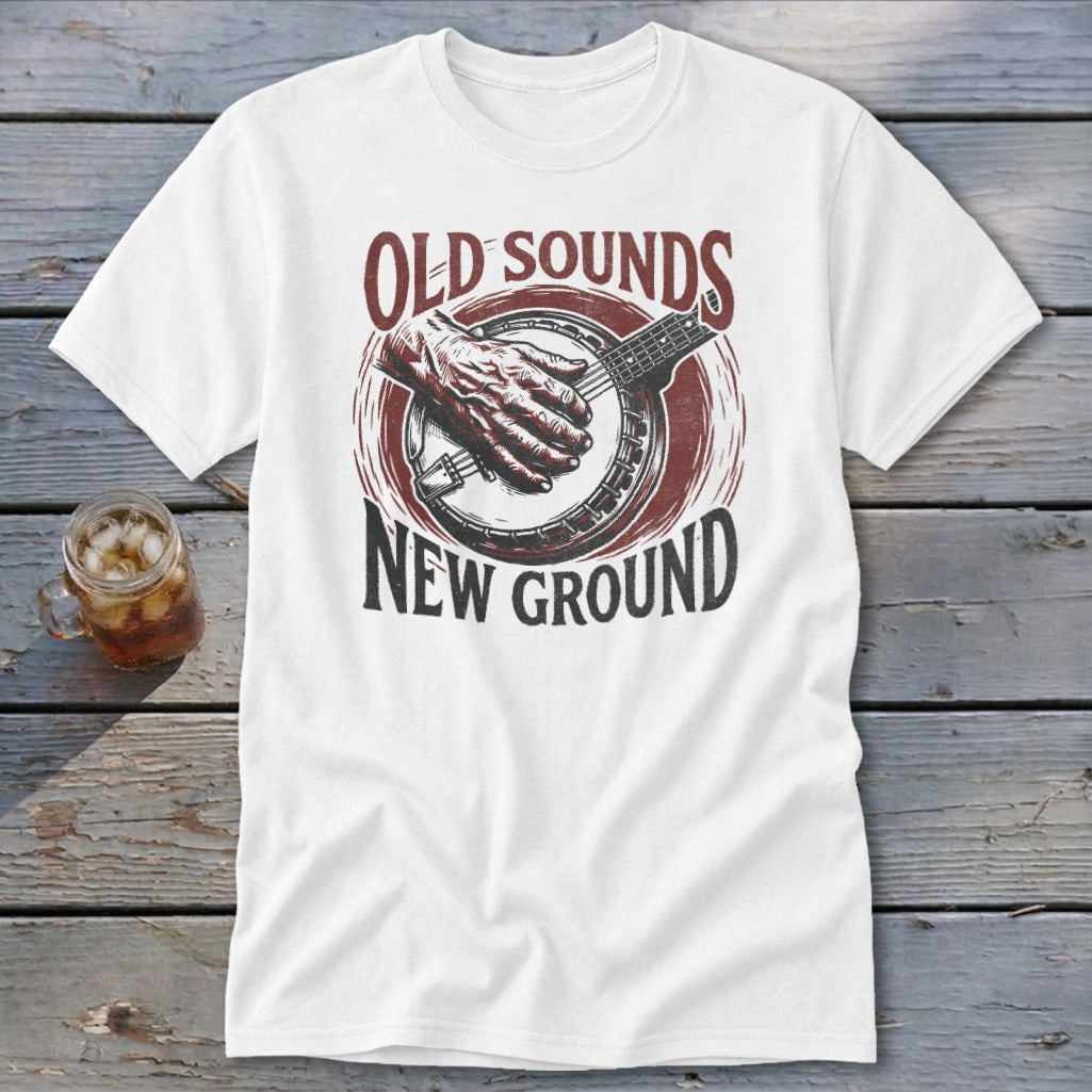 White t-shirt with a graphic of a hand playing a banjo, reading Old Sounds New Ground.