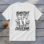 White t-shirt with black graphic: "Barefoot on the Creek Bank" and bare feet by water.
