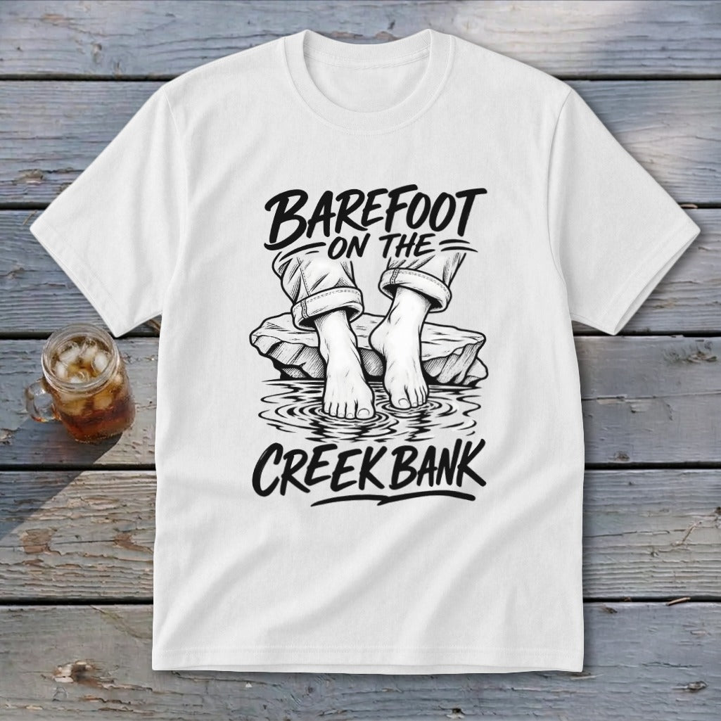 White t-shirt with black graphic: "Barefoot on the Creek Bank" and bare feet by water.