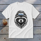 White t-shirt featuring a black and white drawing of a raccoon wearing a beanie with a mountain patch.