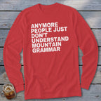 Red long-sleeve shirt with white text: "anymore people just don't understand mountain grammar."