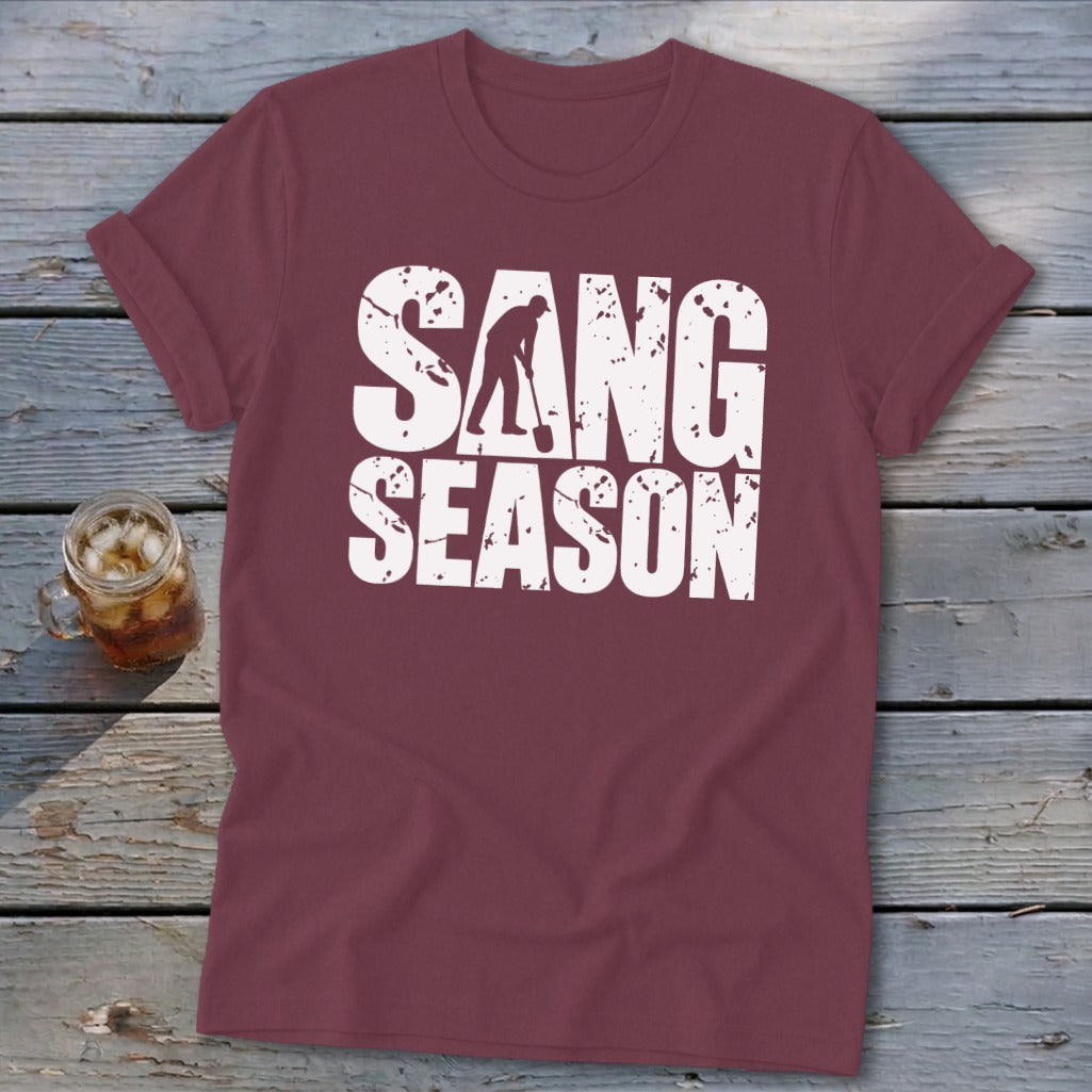 Maroon short-sleeved t-shirt with distressed white text reading SANG SEASON and a silhouette of someone digging.