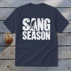 A navy blue short-sleeved t-shirt with the distressed white text SANG SEASON and a digging silhouette.