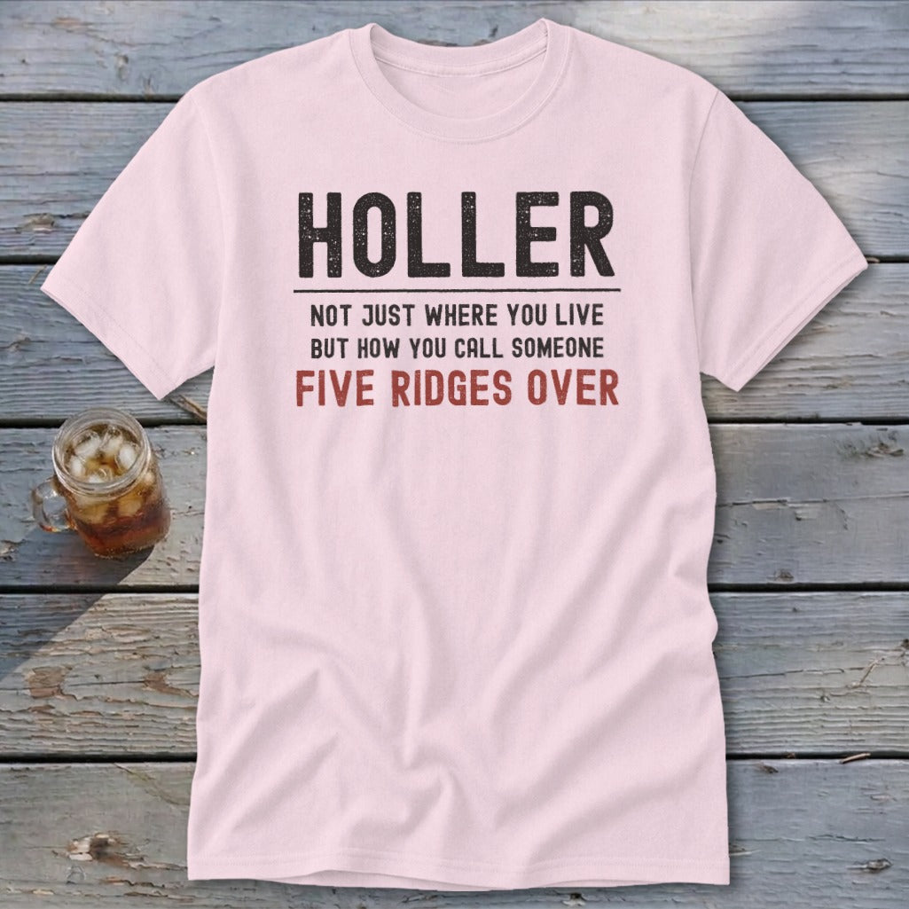 Pink t-shirt with text "HOLLER NOT JUST WHERE YOU LIVE BUT HOW YOU CALL SOMEONE FIVE RIDGES OVER".