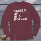 Maroon long-sleeve shirt with "RAISED UP IN A HOLLER" text in white.