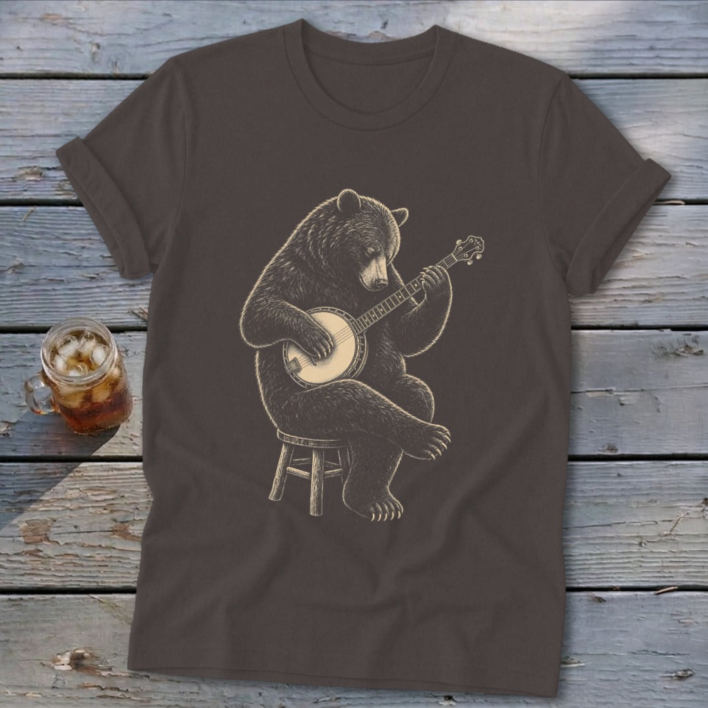 Brown t-shirt with a detailed illustration of a bear playing a banjo on a stool.