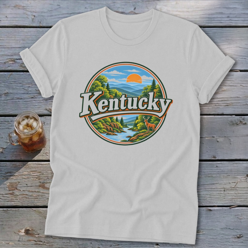White t-shirt with circular Kentucky landscape design featuring mountains, river, trees, deer, and sun.