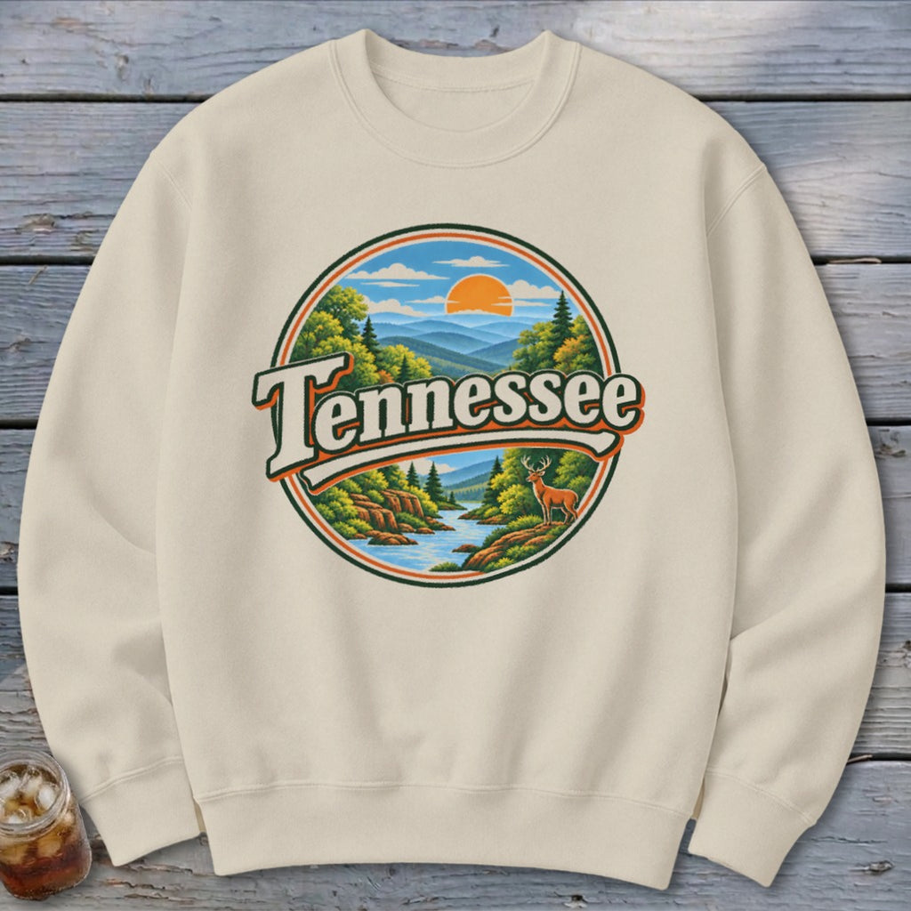 Cream sweatshirt with round graphic of Tennessee landscape with deer and sun.