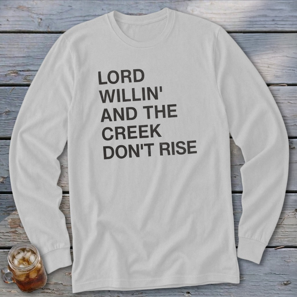 White long sleeve shirt with black text: "LORD WILLIN' AND THE CREEK DON'T RISE".