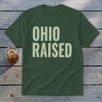 Green t-shirt with "OHIO RAISED" text in large, light-colored font.