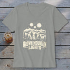 A grey V-neck t-shirt featuring a mountain landscape graphic with three people, glowing lights, and text reading Brown Mountain Lights.