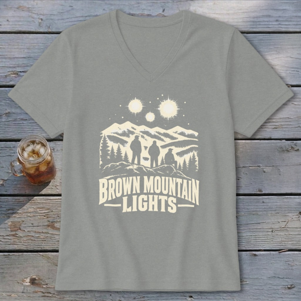 A grey V-neck t-shirt featuring a mountain landscape graphic with three people, glowing lights, and text reading Brown Mountain Lights.