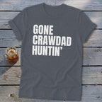 Dark grey t-shirt with white text "GONE CRAWDAD HUNTIN'" and a glass of iced tea.