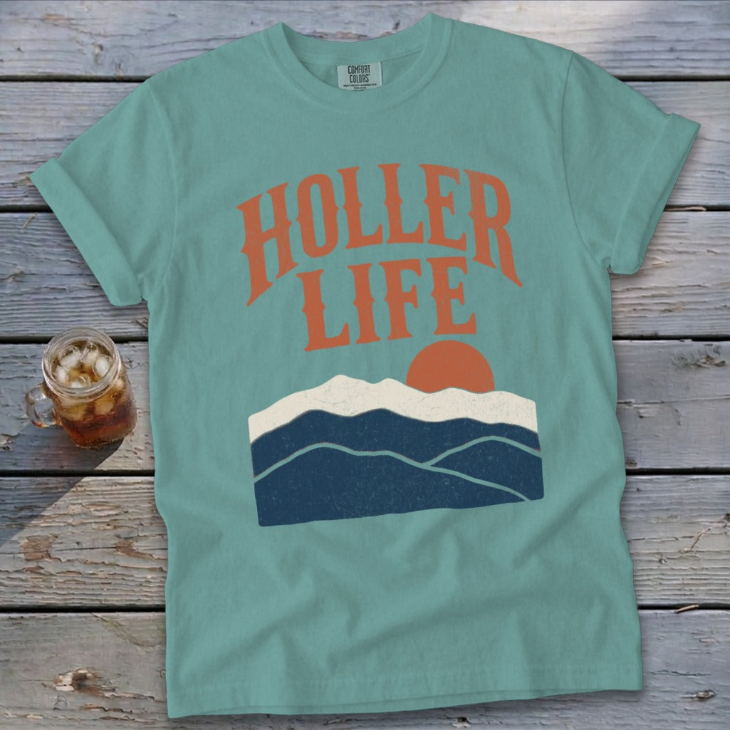 Teal t-shirt with "Holler Life" text and mountain sunset graphic.