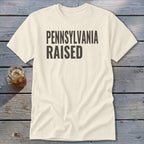 Cream t-shirt with black text reading "PENNSYLVANIA RAISED."