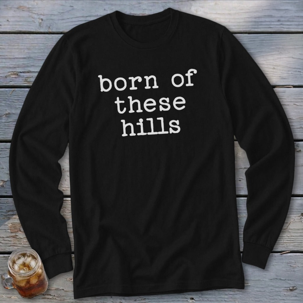 Black long-sleeve shirt with white text "born of these hills".