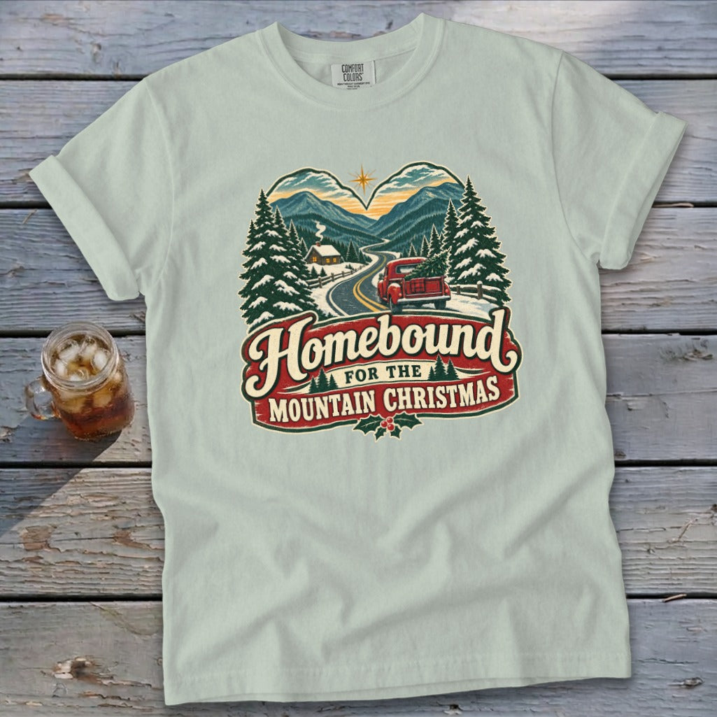 T-shirt with "Homebound For The Mountain Christmas" text and snowy mountain scene.