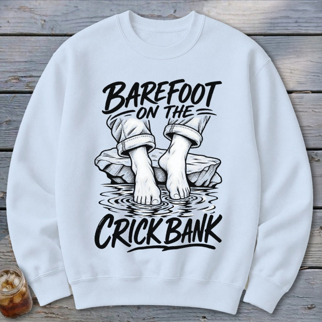 White sweatshirt with "Barefoot on the Crick Bank" graphic of bare feet in water.