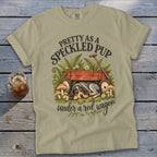 T-shirt with speckled dog sleeping under red wagon and text "Pretty as a speckled pup".
