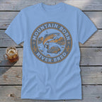 Light blue t-shirt with a circular graphic of a jumping trout and the words "Mountain Born River Bred".