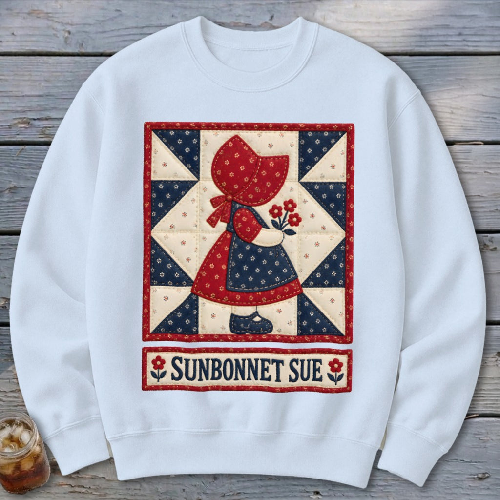 White sweatshirt with a Sunbonnet Sue quilt graphic and text.