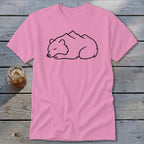 Pink t-shirt with a black outline drawing of a sleeping bear with mountains on its back.