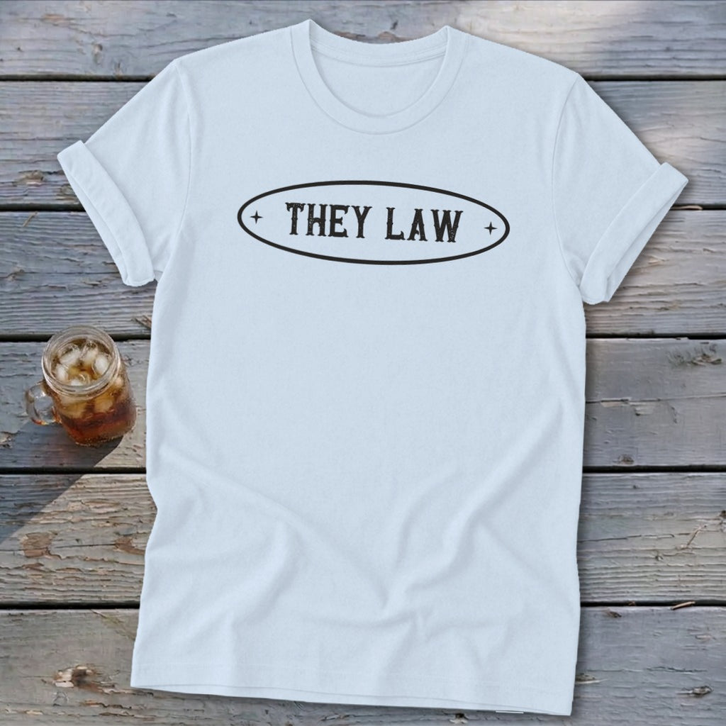 Light blue t-shirt with black text "THEY LAW" inside an oval on the chest.
