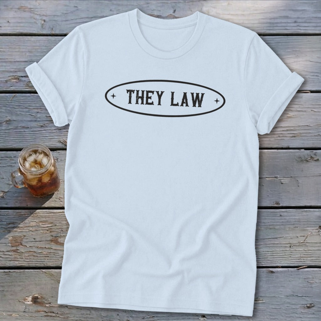 Light blue t-shirt with black text "THEY LAW" inside an oval on the chest.