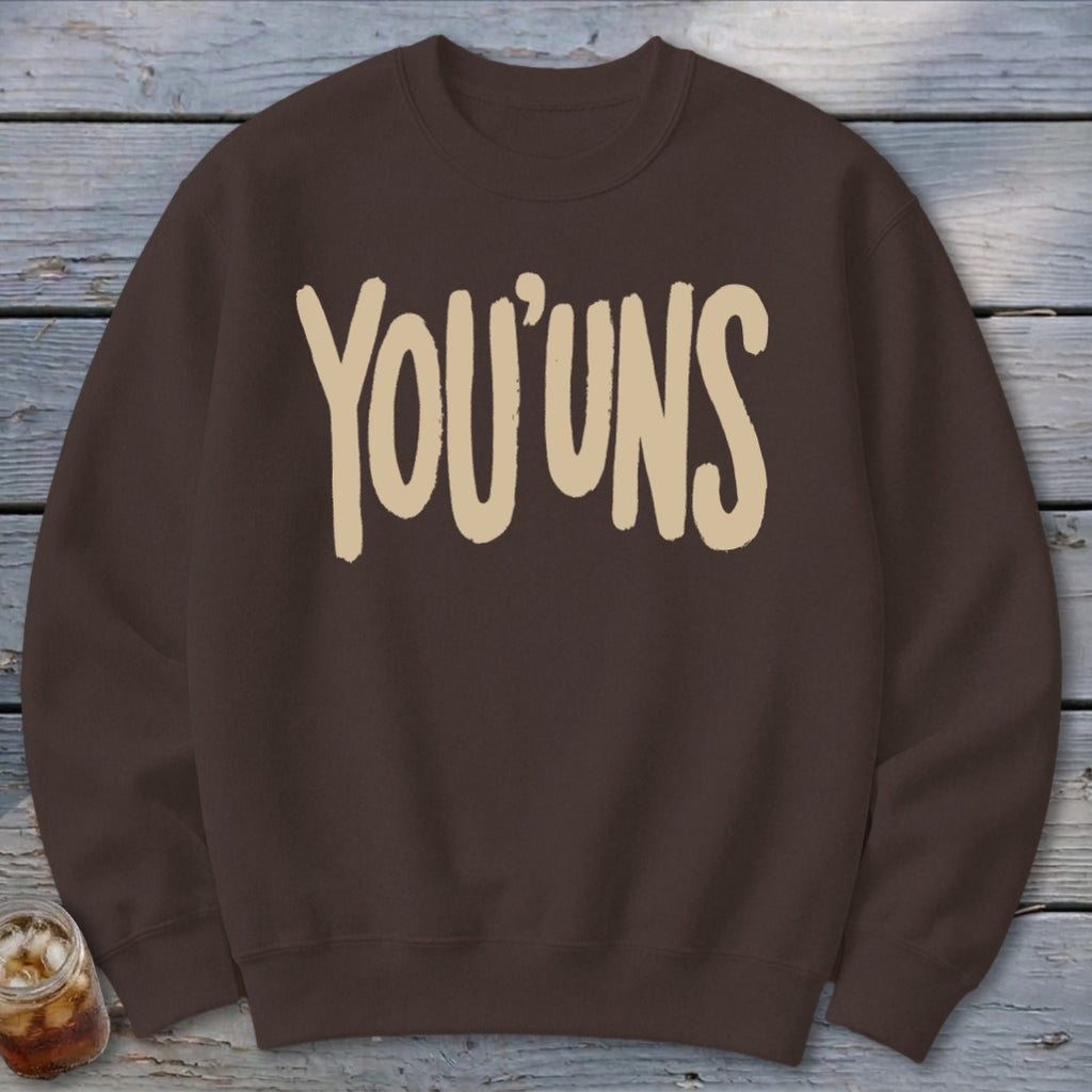 Brown sweatshirt with "YOU'UNS" printed in beige block letters.