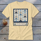 Yellow t-shirt with a quilt design featuring blue and gray triangles and "Flying Geese" text.
