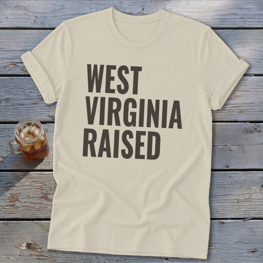 Light beige t-shirt with "WEST VIRGINIA RAISED" text in dark grey.