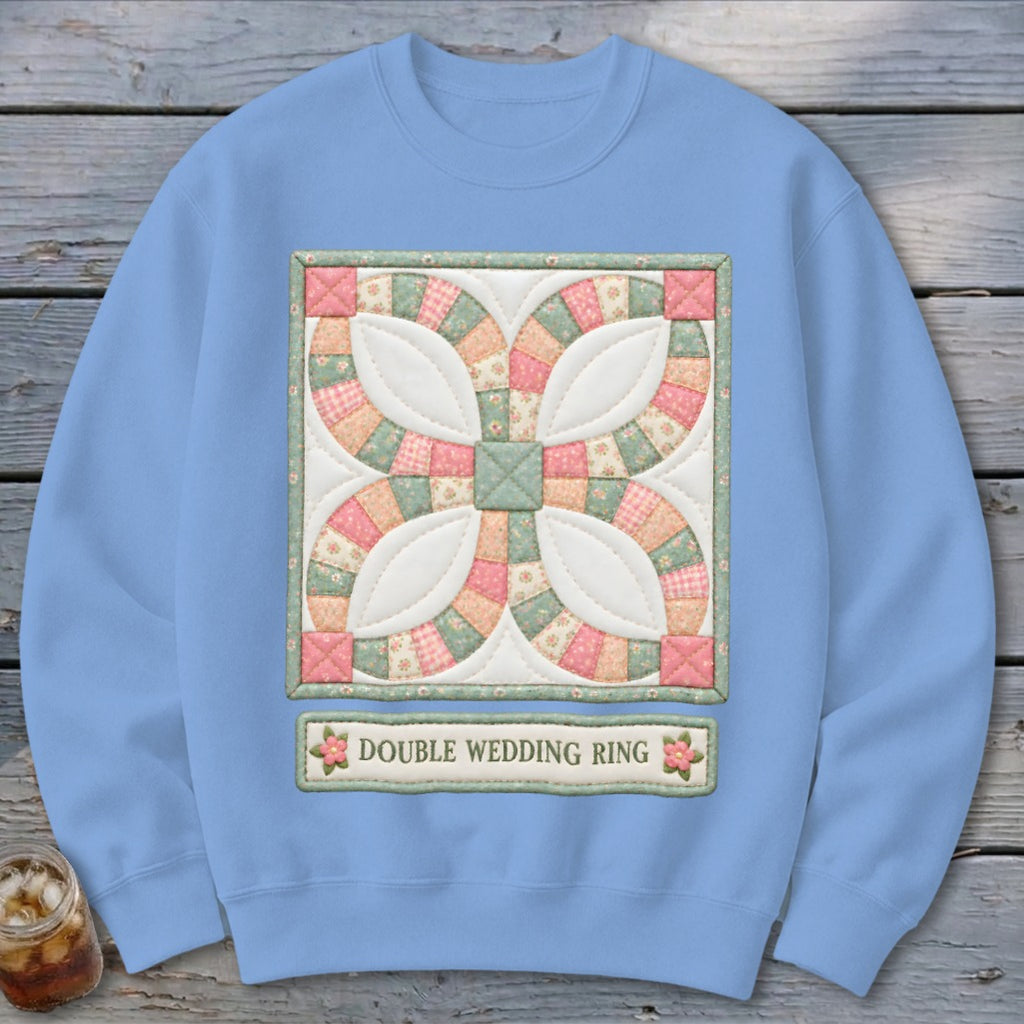 Light blue sweatshirt with a quilt square design and the text "Double Wedding Ring."