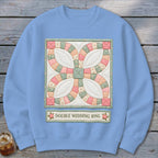 Light blue sweatshirt with a quilt square design and the text "Double Wedding Ring."