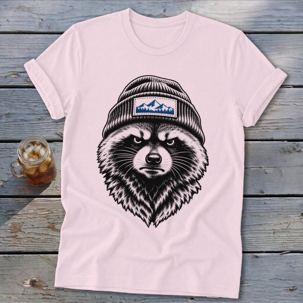 Pink t-shirt with a black and white sketch of a raccoon wearing a beanie with a mountain patch.