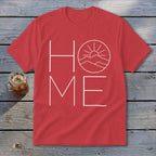 A red t-shirt with white text reading HOME, where the O is replaced by a mountain landscape graphic.