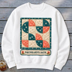 White sweatshirt with a quilt-style graphic featuring a "Drunkard's Path" design.