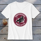 A white V-neck t-shirt featuring a maroon circular graphic of a bear lounging on a porch swing, with the text "PROFESSIONAL PORCH SITTER".