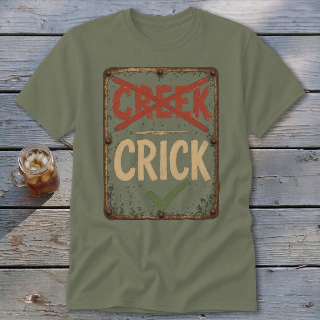 Olive green t-shirt with distressed sign graphic reading "CRICK" with a checkmark and "CREEK" crossed out.