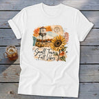 White t-shirt with "Small Town Fall Vibes" text, sunflower, and water tower graphic.