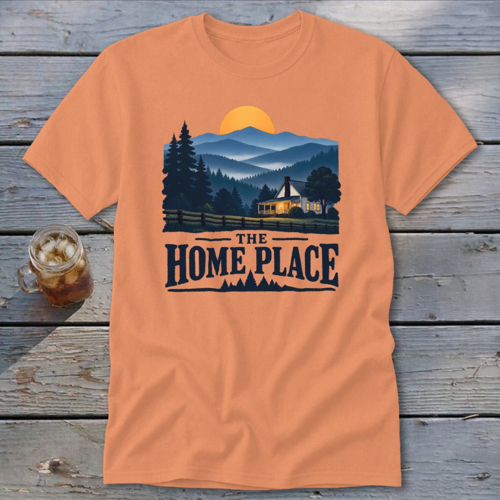 Orange t-shirt with a sunset mountain landscape and text "The Home Place".