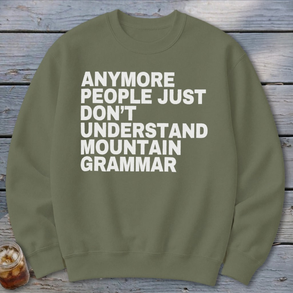 Green sweatshirt with white text: "anymore people just don't understand mountain grammar".