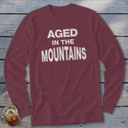 Maroon long-sleeve shirt with "Aged In The Mountains" white text.