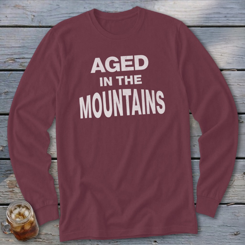 Maroon long-sleeve shirt with "Aged In The Mountains" white text.