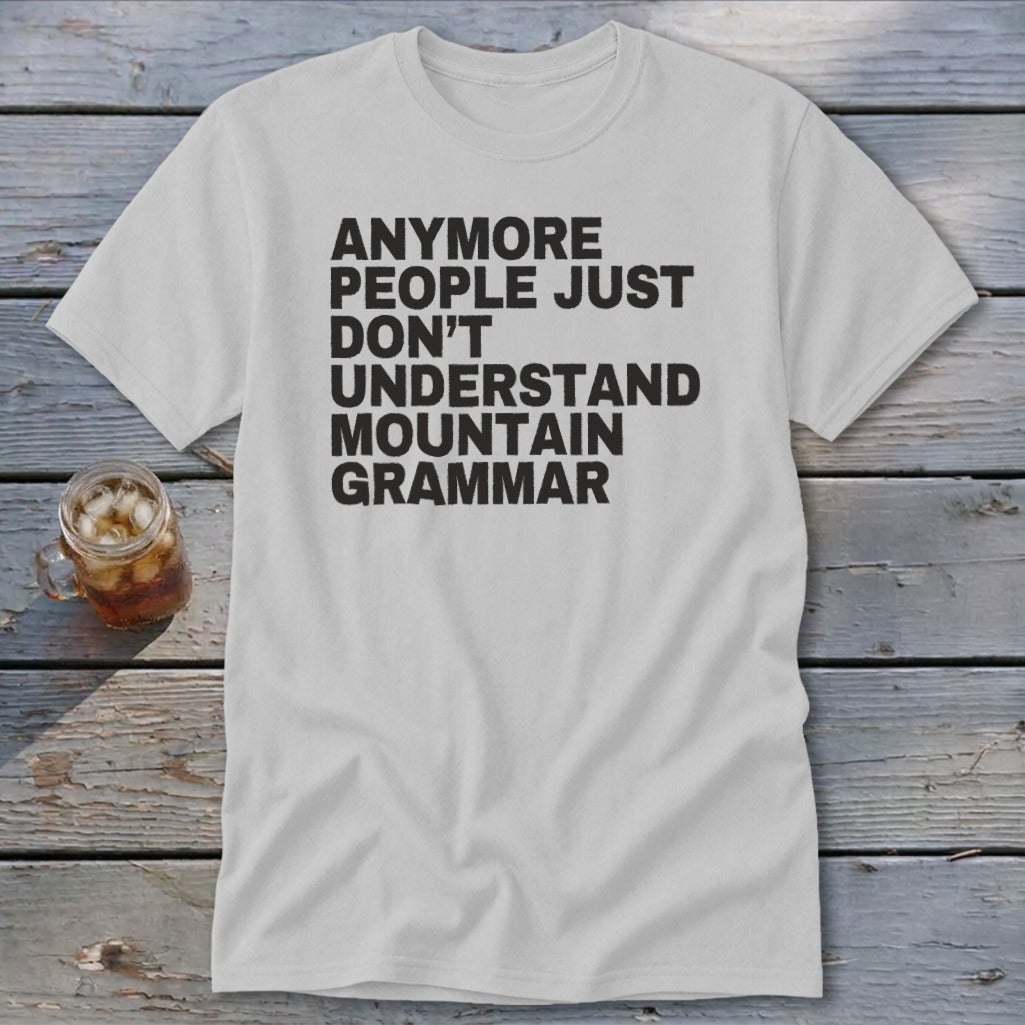 White t-shirt with black text that reads "anymore people just don't understand mountain grammar."
