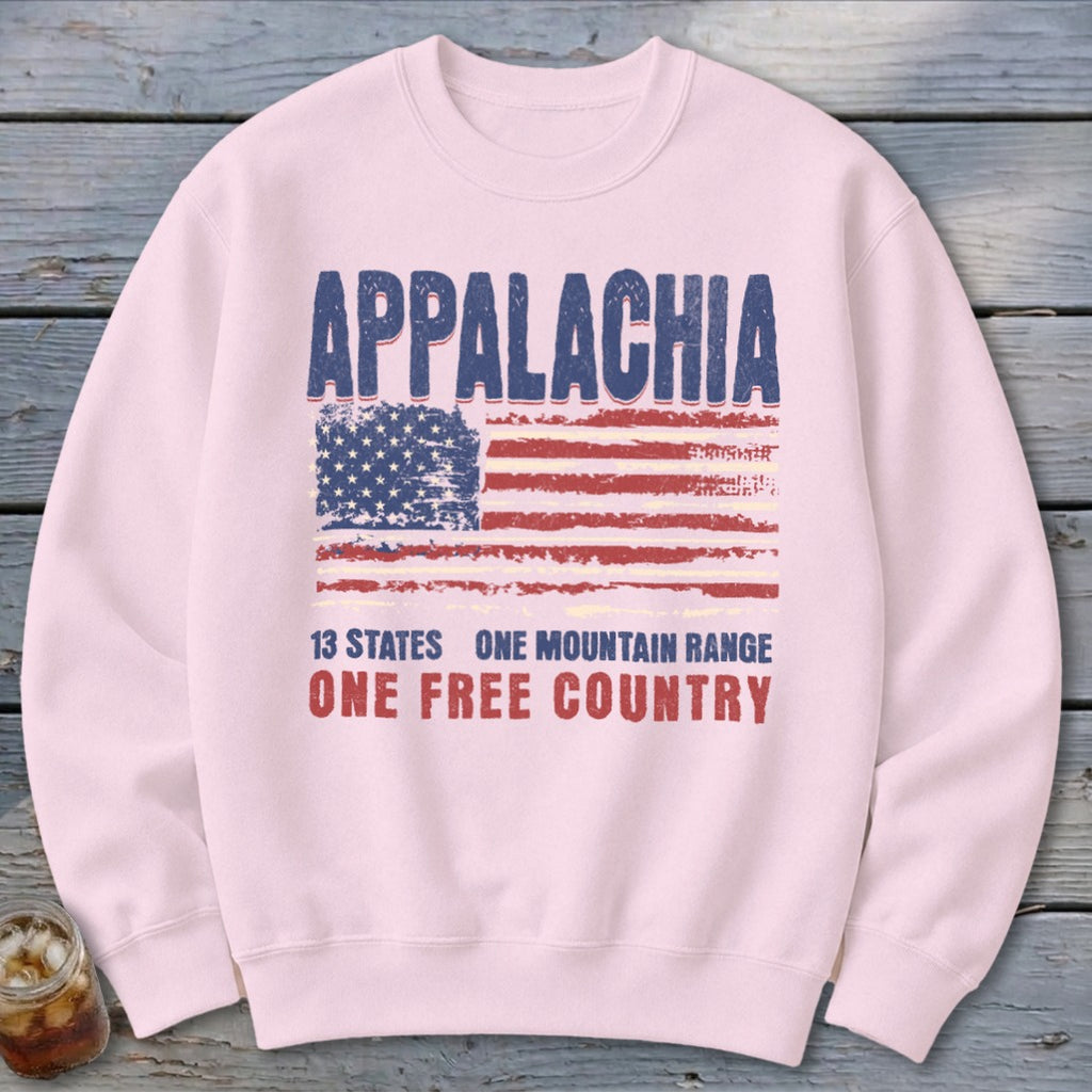 Light pink crewneck sweatshirt featuring a distressed American flag and Appalachian text graphic on the chest.