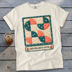 White t-shirt with "Drunkard's Path" quilt pattern and text.